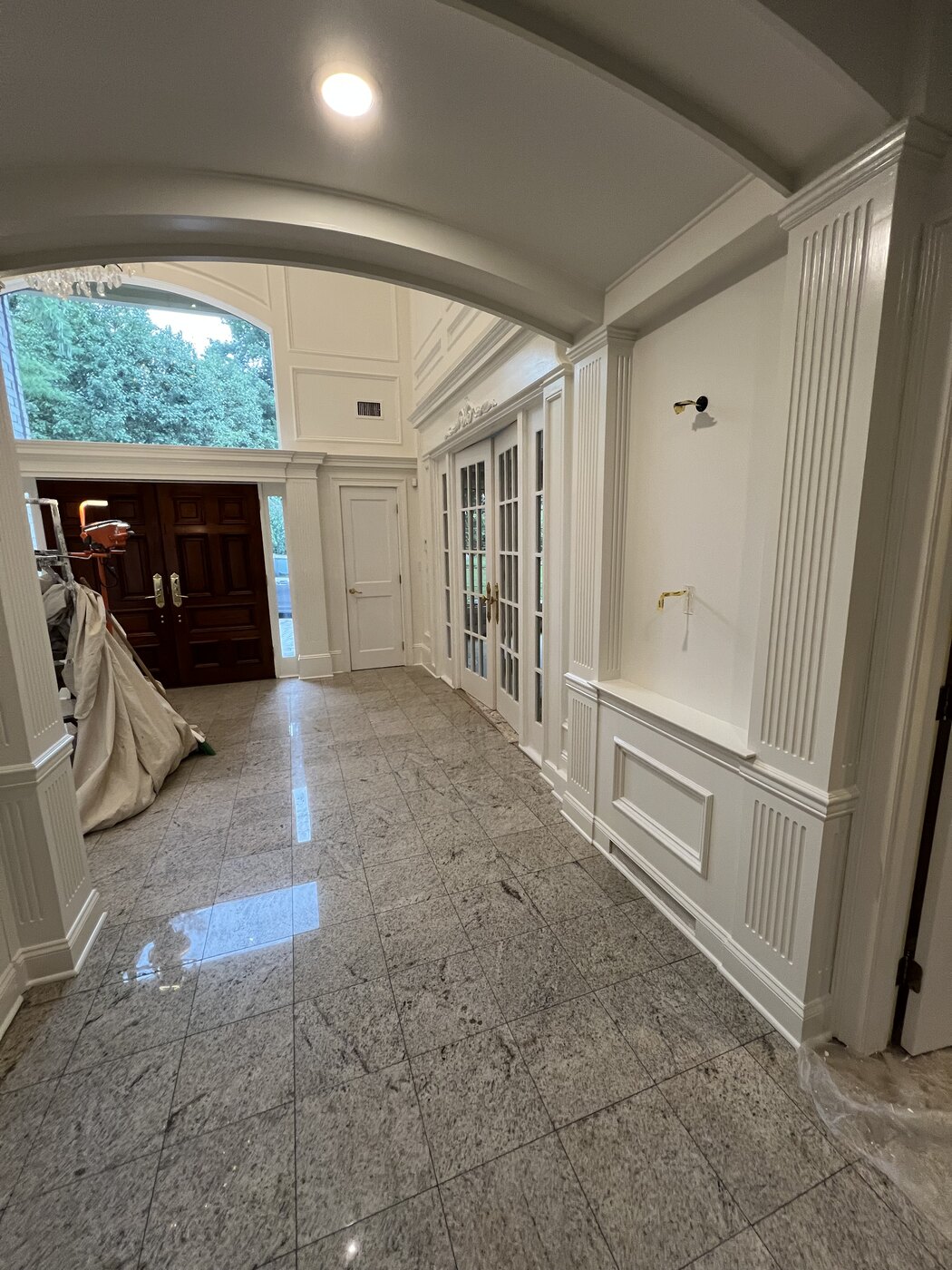 Arched hallway with hand-finished white millwork
